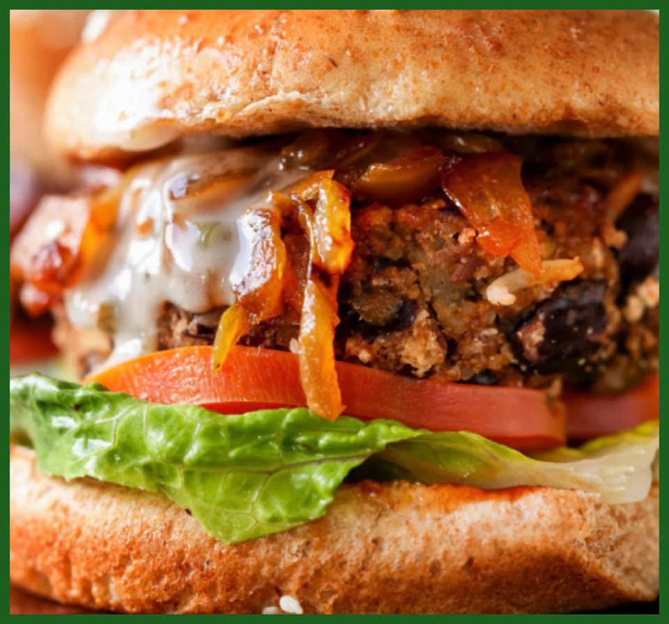 A vegetable burger with caramelized onions and greens
